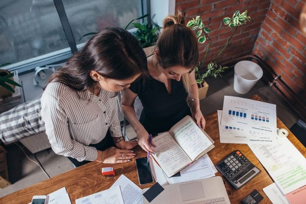 Two female colleagues in office working together. Better in Business Core Business Accountants