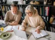 Senior couple collaborating on laptops in a cozy home office setting
