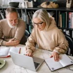 Senior couple collaborating on laptops in a cozy home office setting