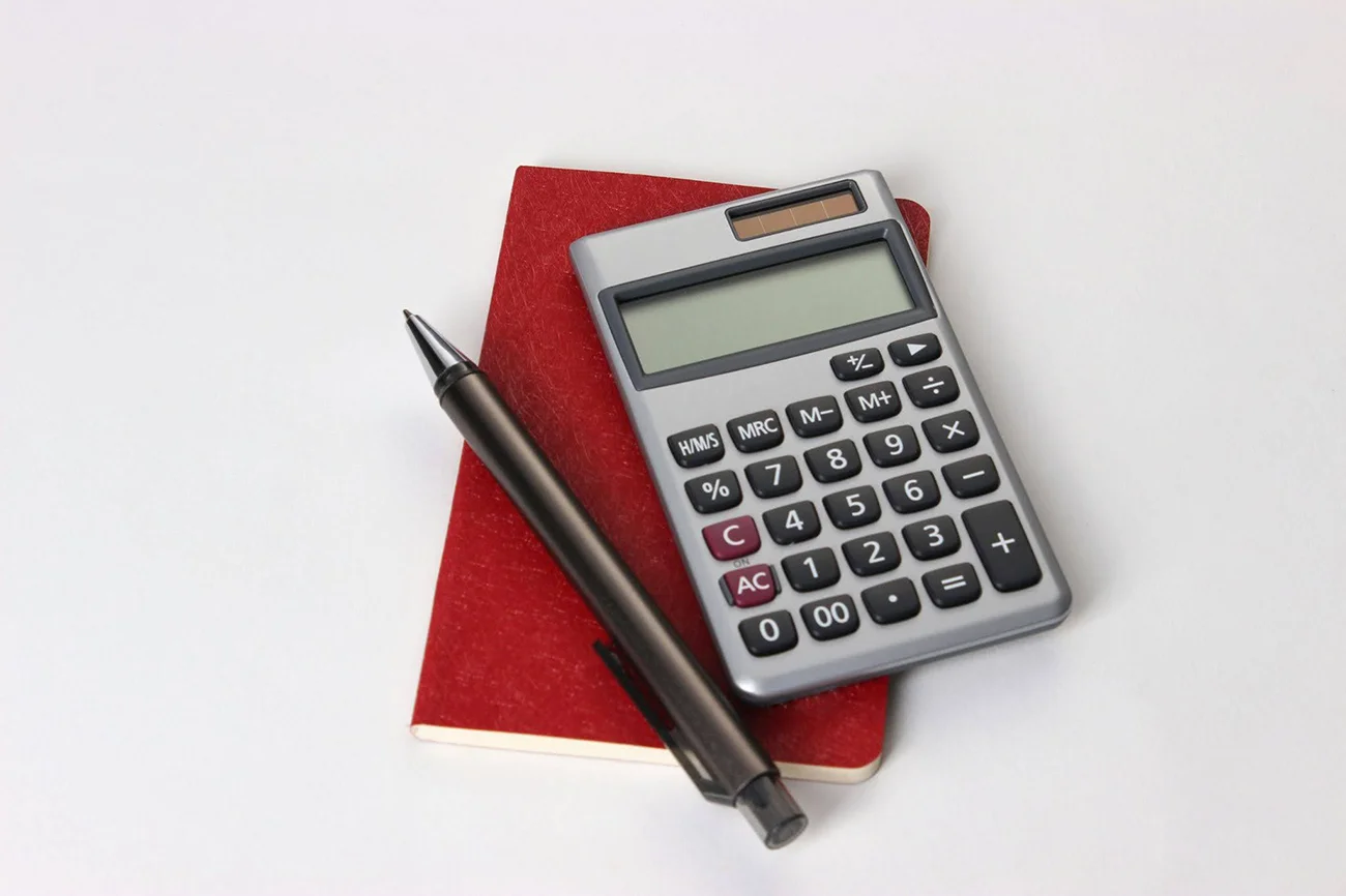 Red notebook and pen with calculator Red notebook and pen with calculator